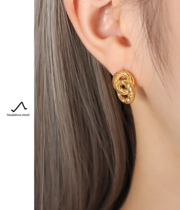 Detail shot of gold-plated stainless steel hoop earrings with sparkling cubic zirconia