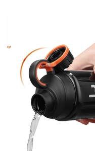 Detail of sports water bottle with leak-proof orange cap and black body 45-degree tilt