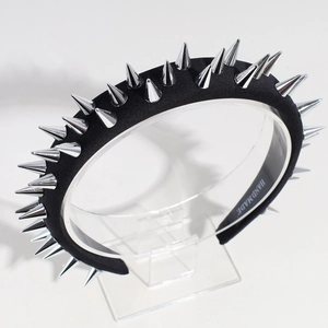 Detail view of black punk headband featuring silver metallic studs and handmade text