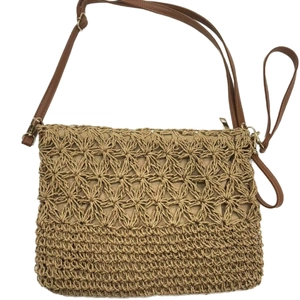 Hollow straw crossbody bag with brown faux leather strap for beach vacation use