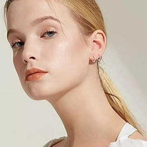 Minimalist silver hoop earrings for women showing actual wearing scale on a model
