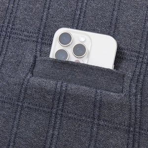 Detailed close-up of dark grey knitted vest pocket showing textured pattern and depth