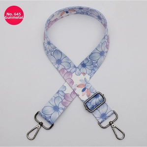 Detail of 38mm wide floral pattern bag strap with gunmetal swivel hooks and adjustment buckle