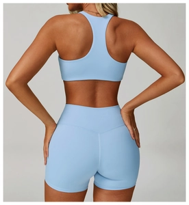Back view of light blue racerback sports bra and high-waist shorts for women