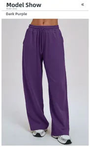 Model wearing loose-fit plum purple wide-leg sports trousers with drawstring waist