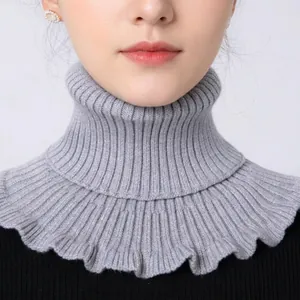 Detailed knit texture of light gray turtleneck faux collar with soft ribbed patterns