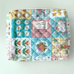 Close-up of quilted floral cotton fabric texture and vintage label on storage bag