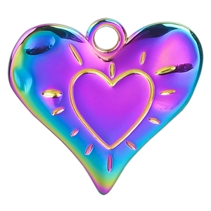 Macro view of a heart pendant featuring 18k gold plated sunburst details and rainbow finish