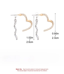 Detail view of heart-shaped twisted earrings in gold and silver finish with size markings