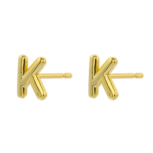 Macro view of 18K gold plated letter K studs featuring a smooth polished metallic finish