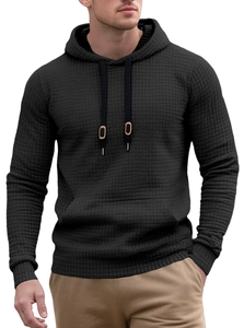 Close-up of black waffle knit fabric texture on men's long sleeve pullover hoodie
