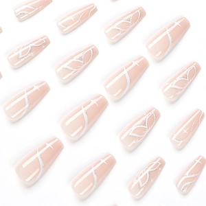 Nude pink coffin press-on nails with white butterfly wing patterns and silver star accents