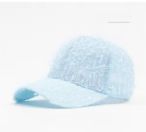 Detail of sky blue baseball cap featuring unique long fiber fringe and textured fabric