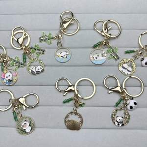 Cute cartoon panda enamel keychains in gold finish with various Sichuan panda poses