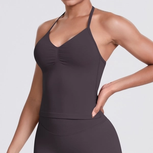 Macro detail of seamless rib-knit yoga tank top with thin halter straps and gathered bust