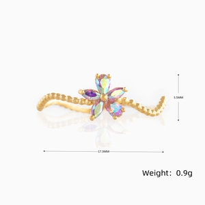Detail view of wavy gold flower ring with colorful gemstones and 17.3mm size dimensions