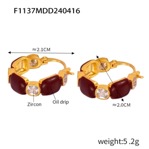 Detail of gold hoop earrings with dark red enamel and zircon, including size measurements