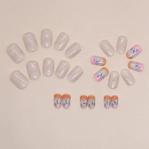 Short square press-on nails with butterfly patterns and glitter foil accents