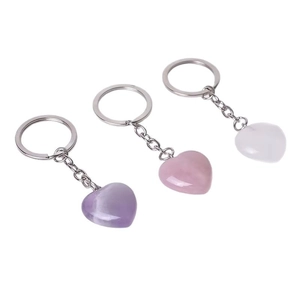 Three-piece heart-shaped natural crystal keychains in amethyst, rose, and clear quartz