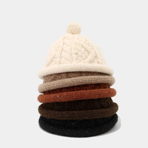 Chunky knit beanie hats for winter in five colors with top knot detail and textured finish