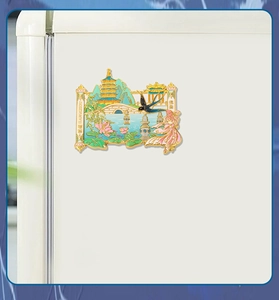 Detail of Hangzhou West Lake metal fridge magnet with gold enamel finish on white background