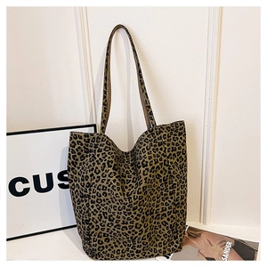 Macro shot of large leopard print tote bag with stylish shoulder straps on a clean background