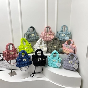 Quilted cloud crossbody bag with bow buckle and fur pompom in multiple colors