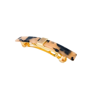Detailed close-up of a French style tortoiseshell acetate spring hair clip with gold accents