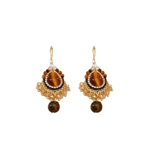 Vintage gold teardrop tiger eye earrings with pearls and crystals on white background