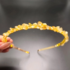 Detail of handmade gold wire crown headband featuring natural yellow citrine crystals