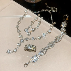 Elegant silver jewelry set with necklace bracelet and ring featuring brilliant diamond sparkle