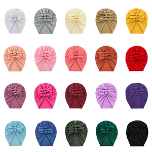 Detailed grid showing 20 colorful baby headbands with triple-knot bow designs in soft cotton