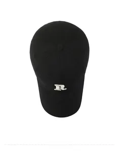 Top-down view of black cotton baseball cap with white 3D R-letter embroidery details