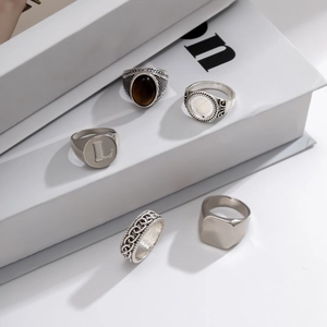 Detail view of 5-piece vintage silver ring set with tiger eye stone and letter L engraving
