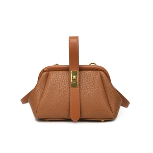 Brown textured leather handbag with gold buckles shown on white background