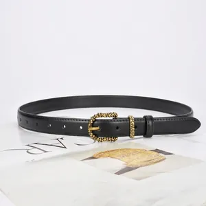 Minimalist black leather belt for women with vintage gold embossed buckle on magazine