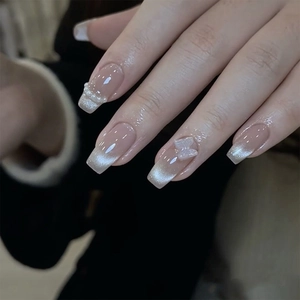 Cat eye press-on nails with 3D butterfly, pearls, and glossy nude pink finish
