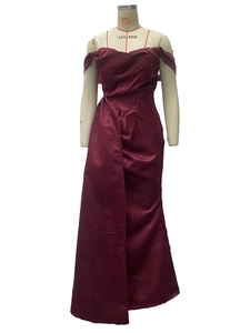Detailed shot of burgundy satin party dress featuring off-shoulder neckline and waist cut