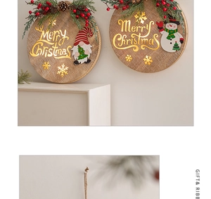 Detail of wooden Merry Christmas hanging sign with snowman, gnome and pine cone decor