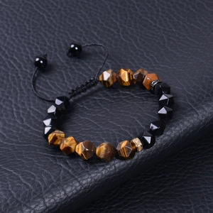 Detailed view of faceted turquoise and obsidian beaded bracelet with tiger eye stones