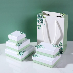 Minimalist white and green jewelry gift boxes with fresh eucalyptus leaf patterns