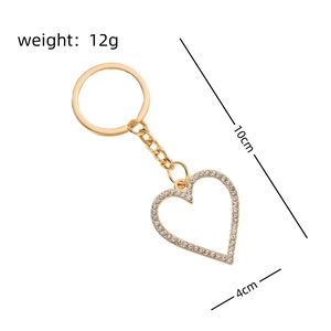 Detailed view of a gold heart keychain with white rhinestones and size measurements