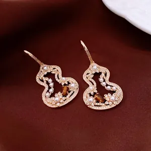 Vintage gold hollow gourd earrings with tiger eye stone and pearls on silk