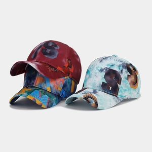 Detailed view of three baseball caps featuring S logo and digital street style graphics
