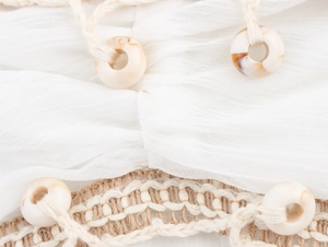 Detail of white wrinkled fabric with hemp rope weaving and marble pattern ring buckles