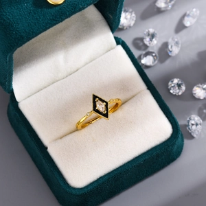 Vintage gold rhombic ring with black inlay and crystals in a green velvet box