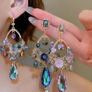 Elegant gold-tone teardrop earrings with multi-colored crystals and floral accents