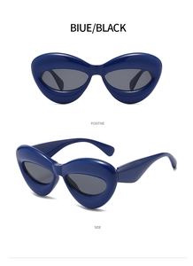 Detail view of bold blue cat-eye sunglasses with thick frames and smoke lenses