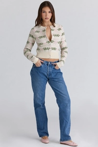 Detail of slim-fit knit cardigan with green leaves and pink bow jacquard patterns