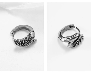 Detail of vintage silver dragon hoop earrings with 3D relief and antique finish